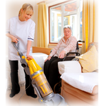 Personal care aide vacuuming an apartment in Richmond VA